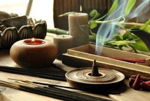 Close-up of assorted incense products representing Zen idea VARIOUS TYPES OF INCENSE WITH TEAPOT AND BUDDHA STATUE